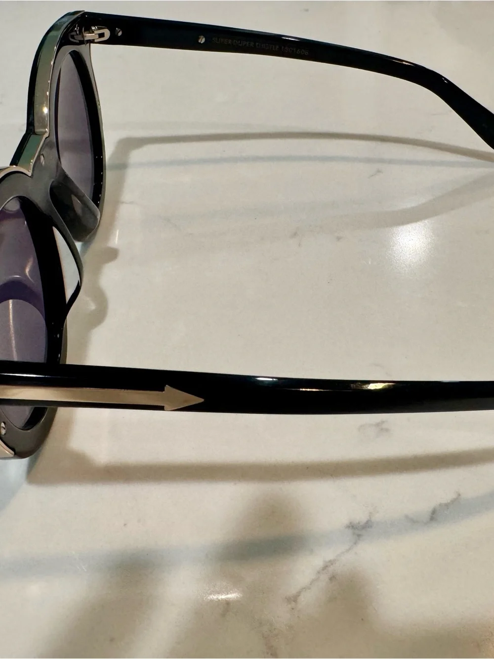 Karen Walker Black Round Sunglasses with Gold Detail and Purple Tint Lenses